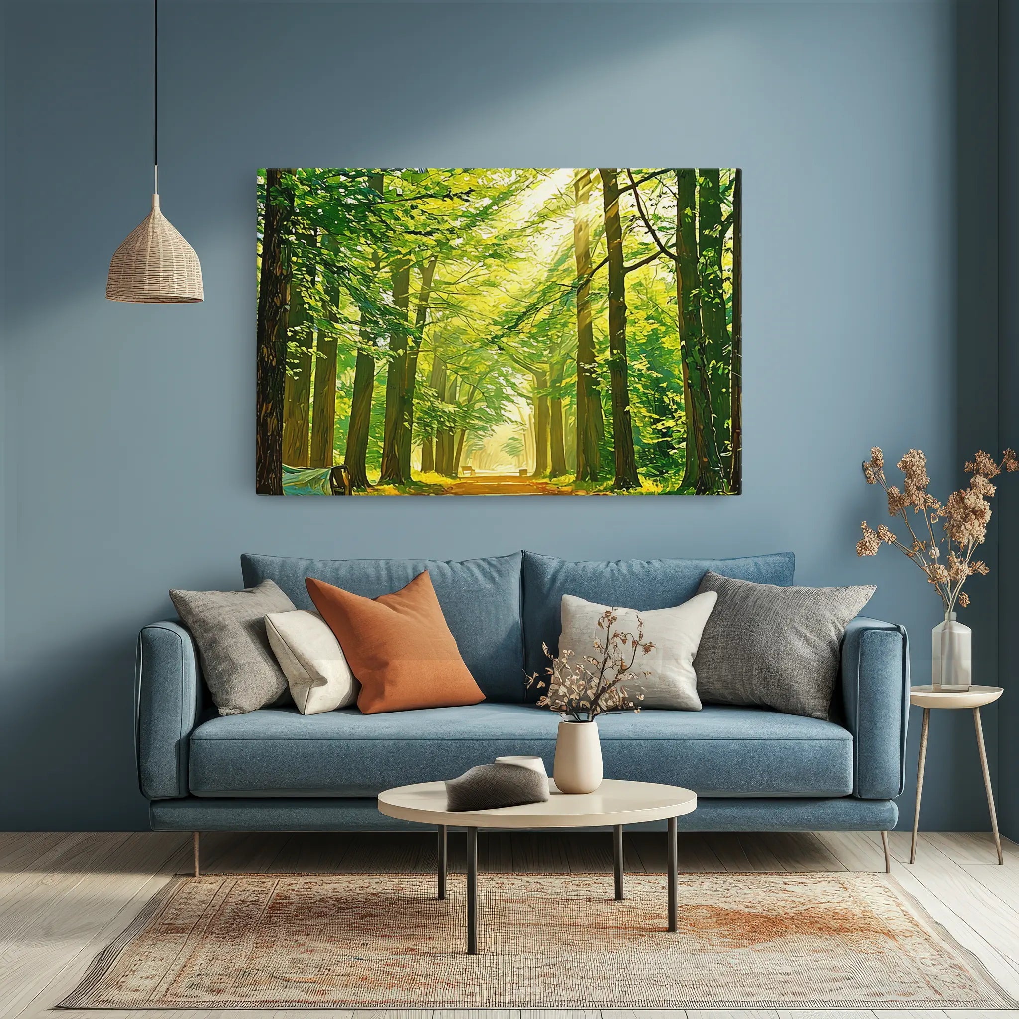 A cozy living room with a blue sofa, assorted pillows, a round coffee table, and a forest landscape painting on the wall.