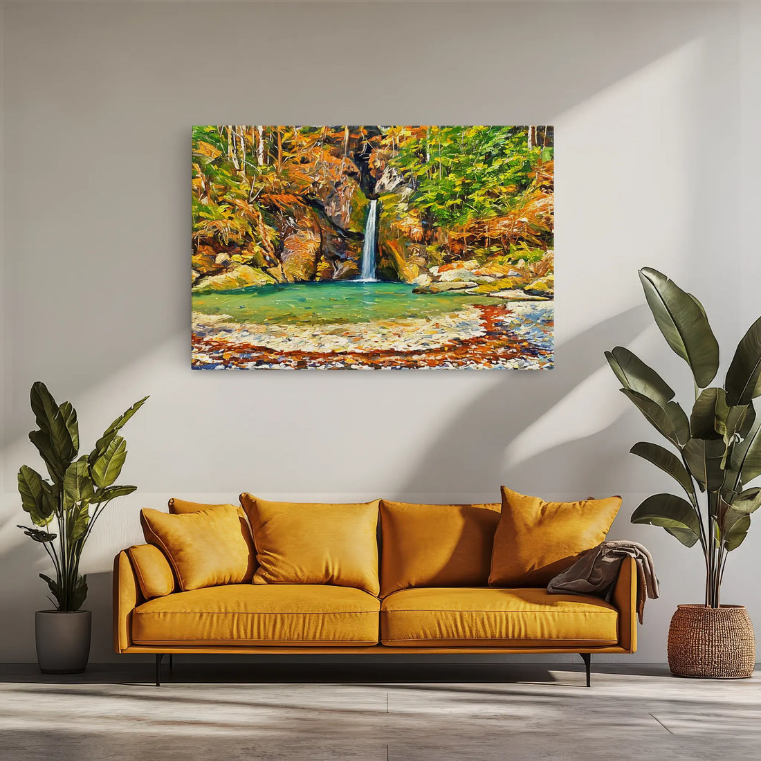 A vibrant painting of a waterfall in a forest hangs above a mustard yellow sofa, flanked by two potted plants.