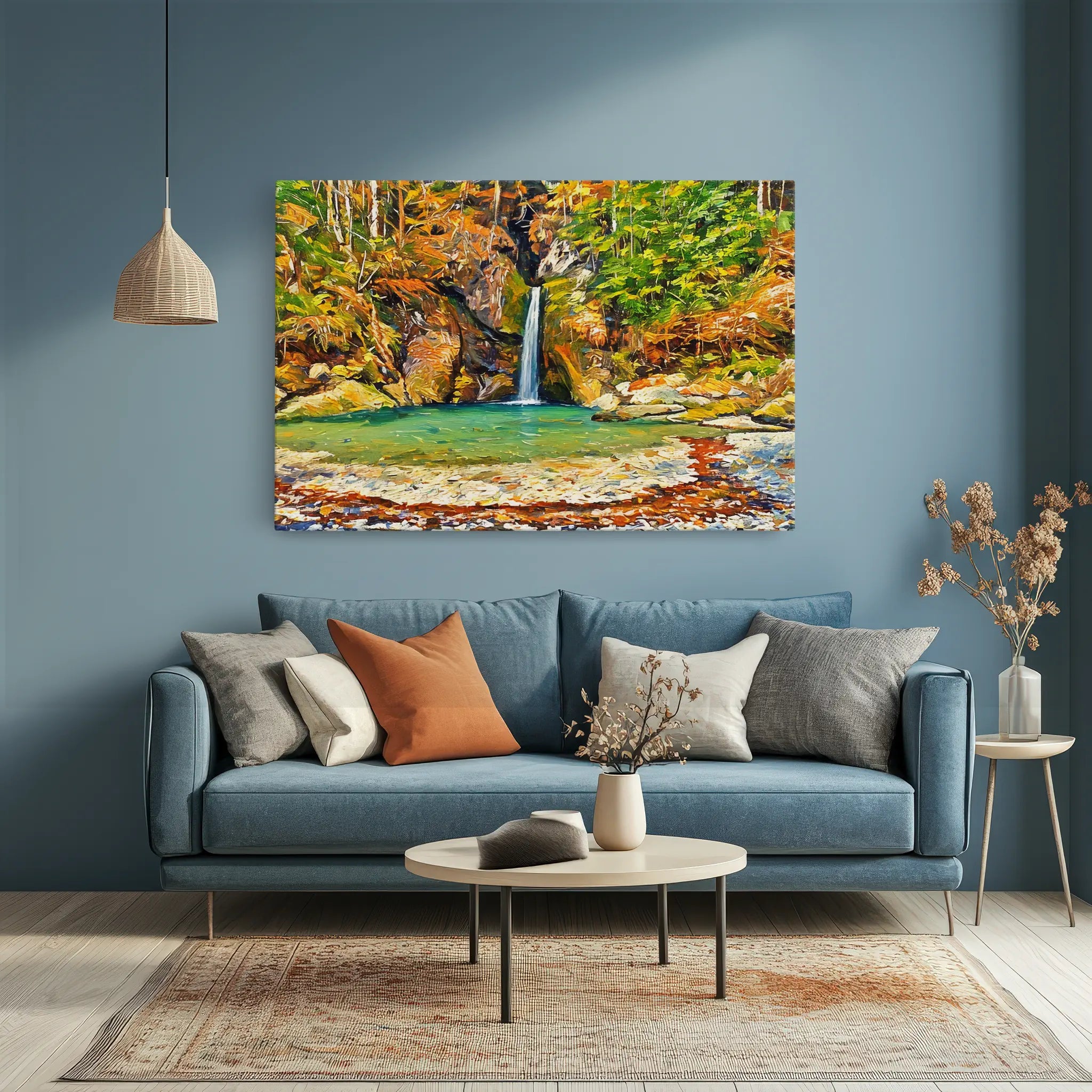 A cozy living room with a blue sofa, assorted pillows, a round coffee table, and a colorful landscape painting on the wall.