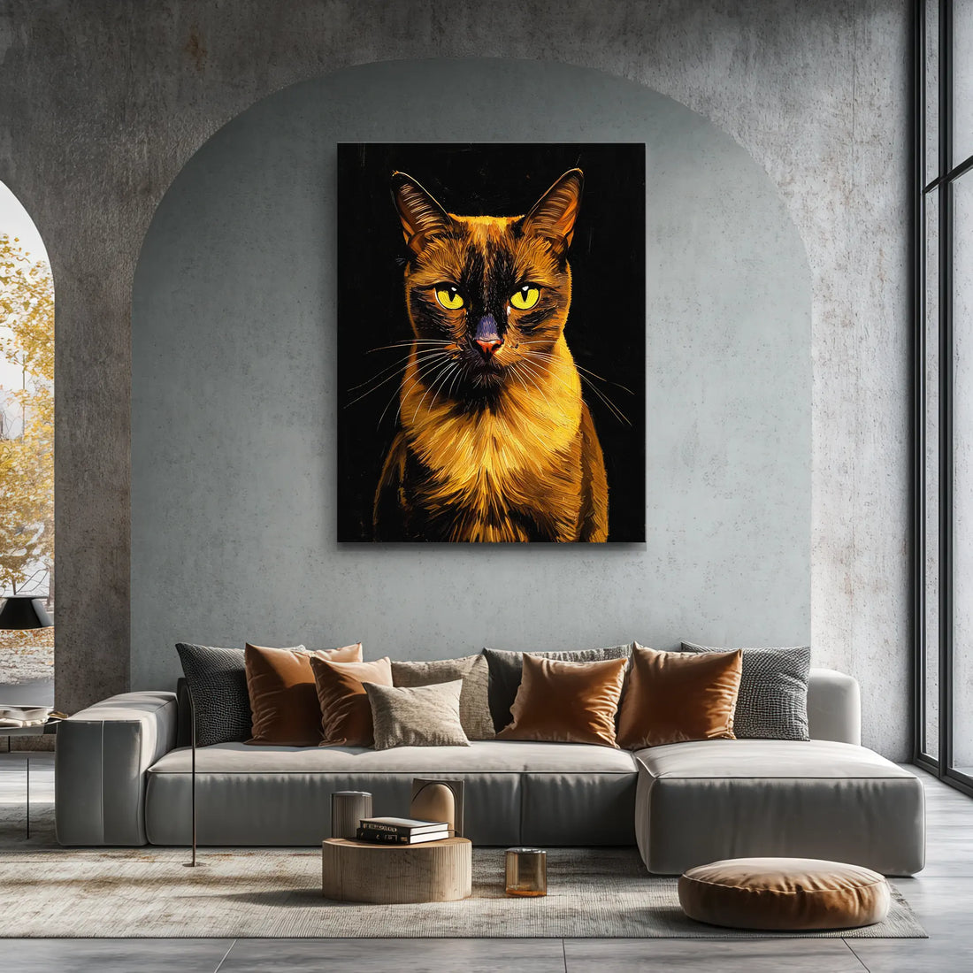 A modern living room with a large, striking cat portrait on the wall above a gray sectional sofa adorned with brown and beige cushions.